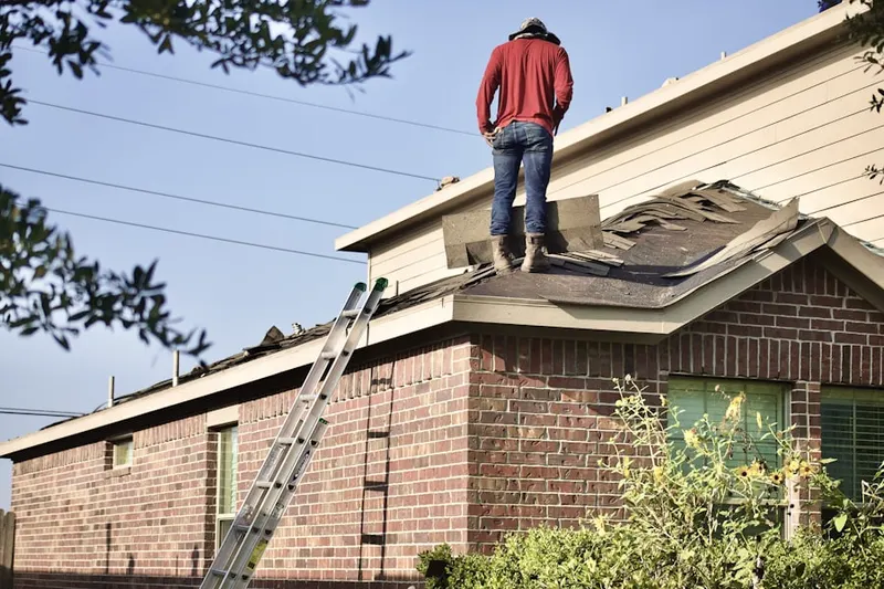 Professional roofer working on a residential roof in Galena